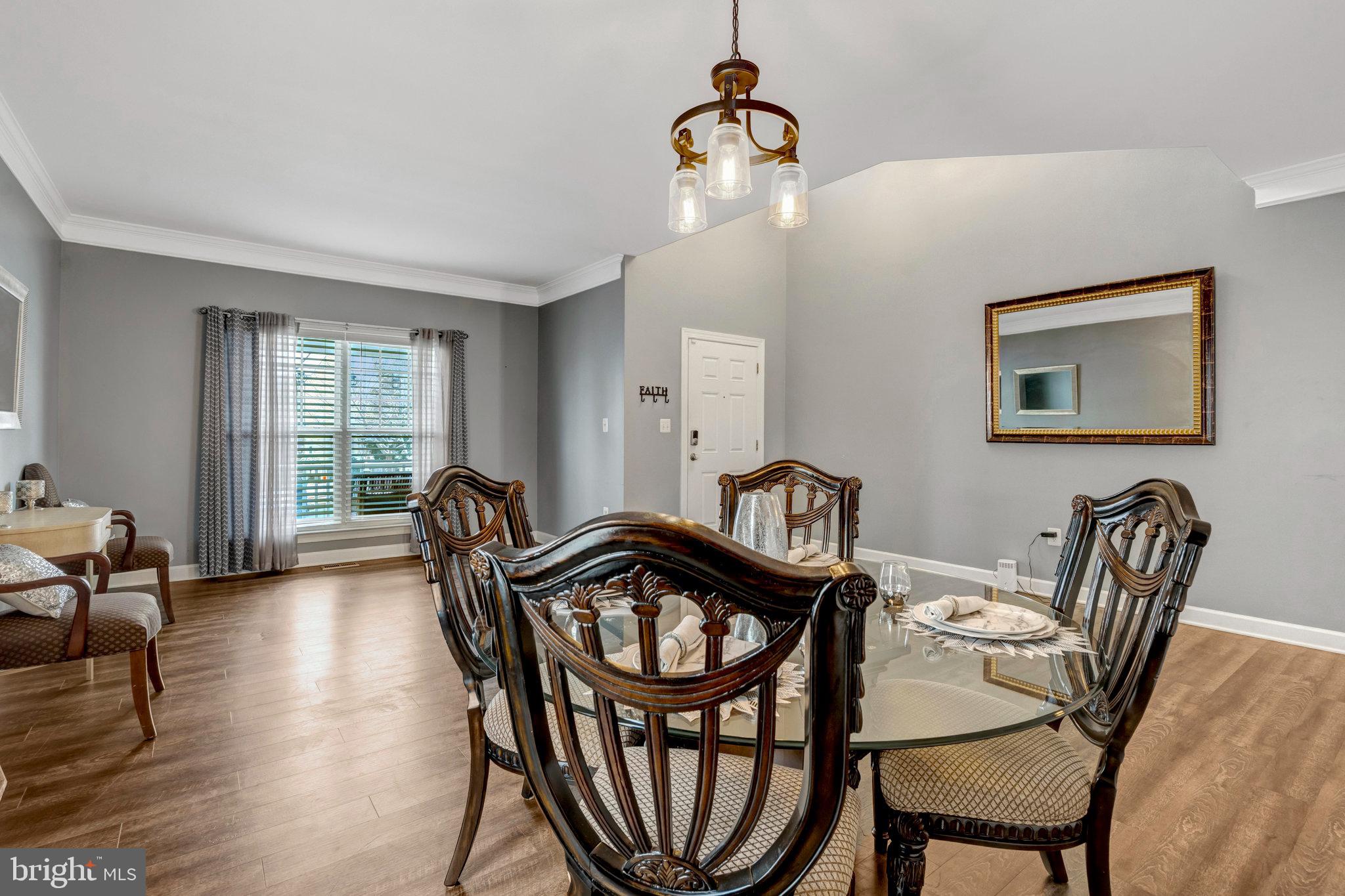 4169 Agency Loop Triangle, VA 22172 - Photo 3 of 56 a view of a dining room with furniture window and wooden floor