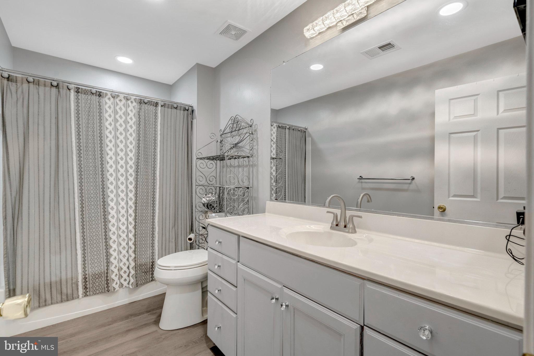 4169 Agency Loop Triangle, VA 22172 - Photo 33 of 56 a bathroom with a double vanity sink toilet and shower