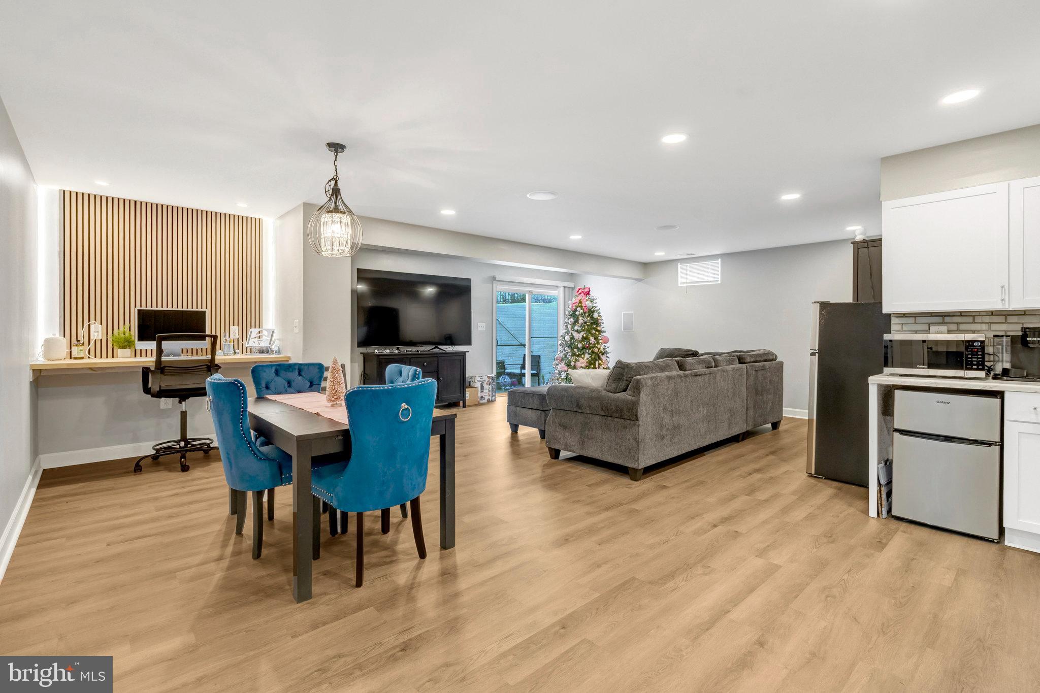 4169 Agency Loop Triangle, VA 22172 - Photo 39 of 56 a living room with furniture flat screen tv and kitchen view