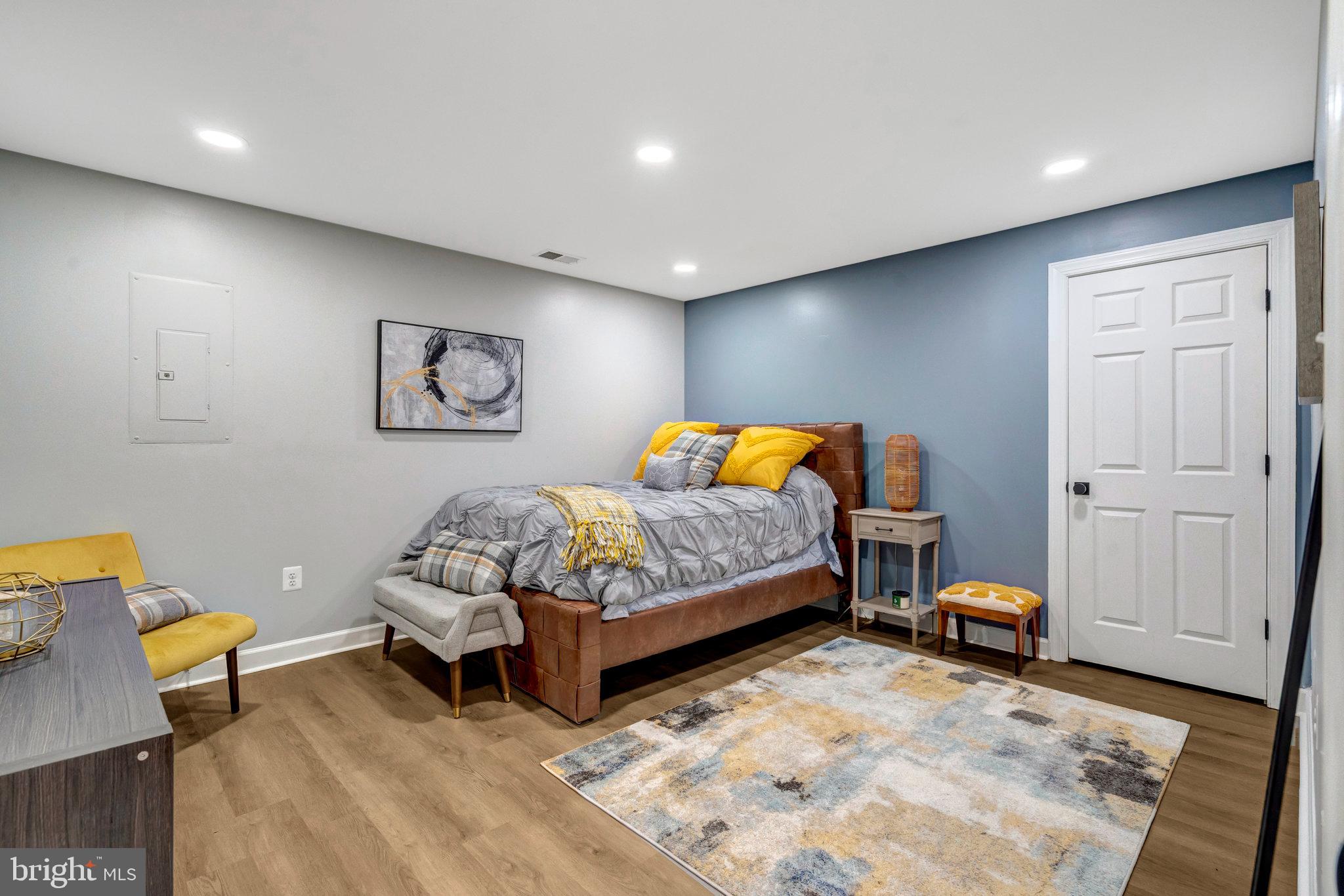 4169 Agency Loop Triangle, VA 22172 - Photo 42 of 56 a bedroom with a bed and a lamp on dresser