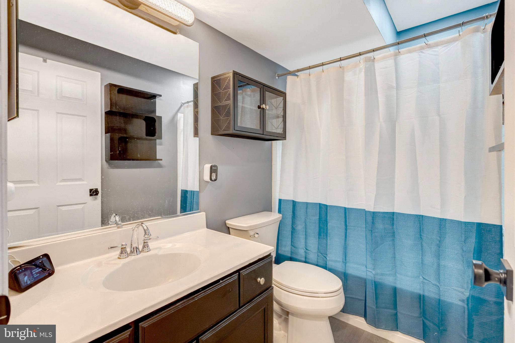 4169 Agency Loop Triangle, VA 22172 - Photo 44 of 56 a bathroom with a sink a toilet and shower curtain