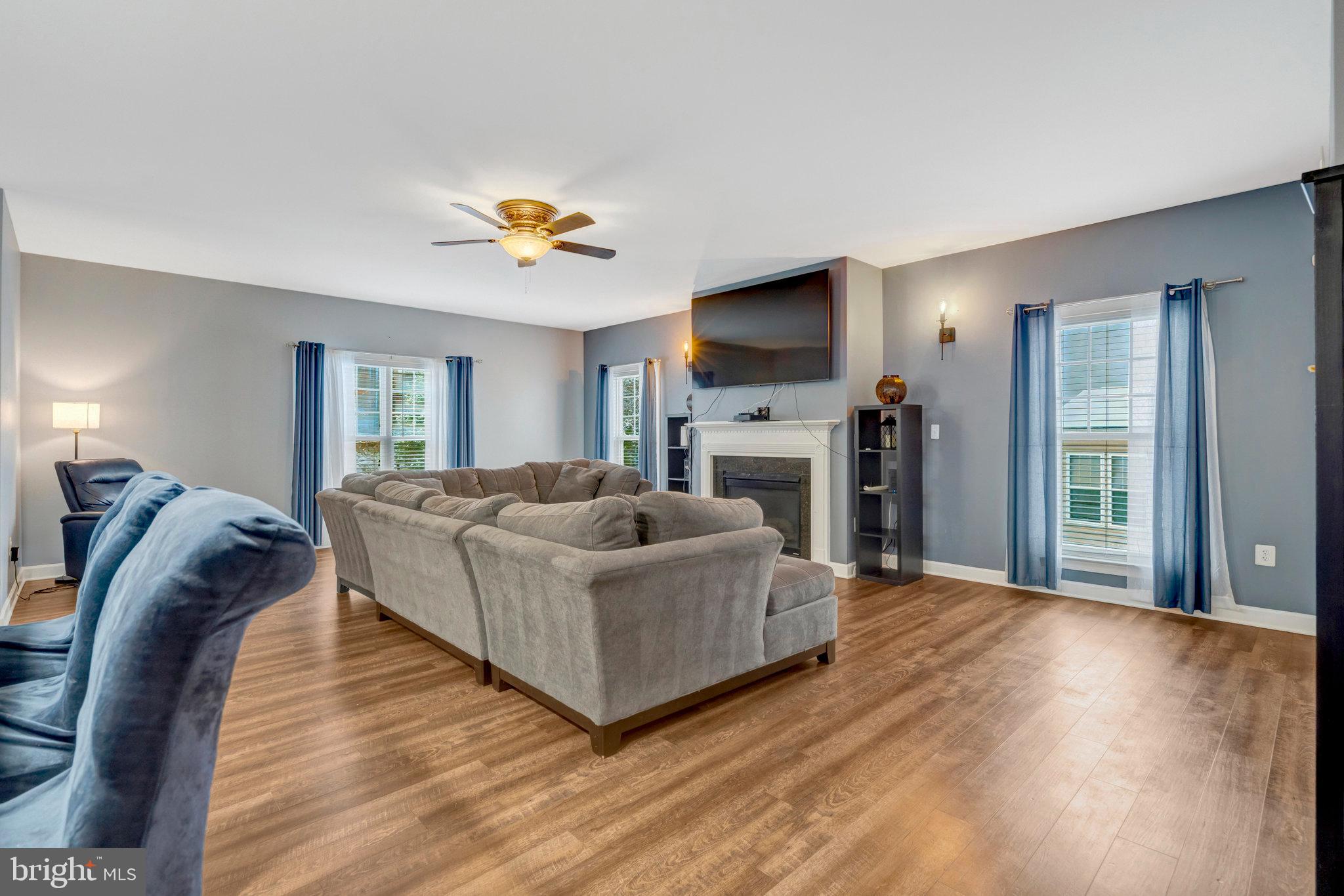4169 Agency Loop Triangle, VA 22172 - Photo 6 of 56 a living room with furniture a flat screen tv and a fireplace