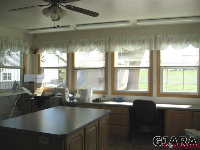 1452 16 Road Loma, CO 81524 - Photo 9 of 13 a kitchen with a table chairs stove and cabinets