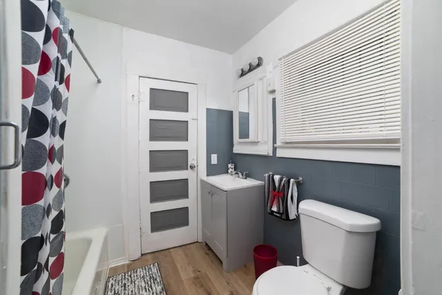 a white toilet sitting next to a bathroom sink and vanity
