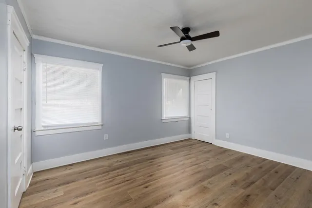 wooden floor in an empty room with a window