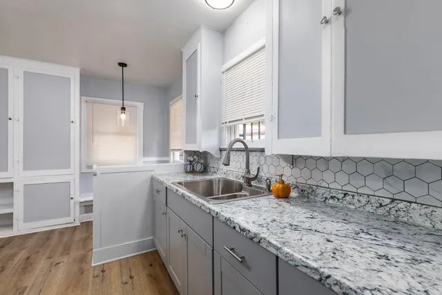 a kitchen with a sink and cabinets