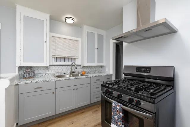 a kitchen with a stove and a sink