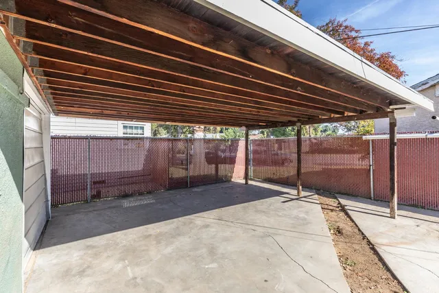 a backyard of a house with barbeque oven table and chairs