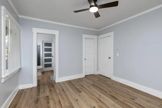 a view of empty room with wooden floor