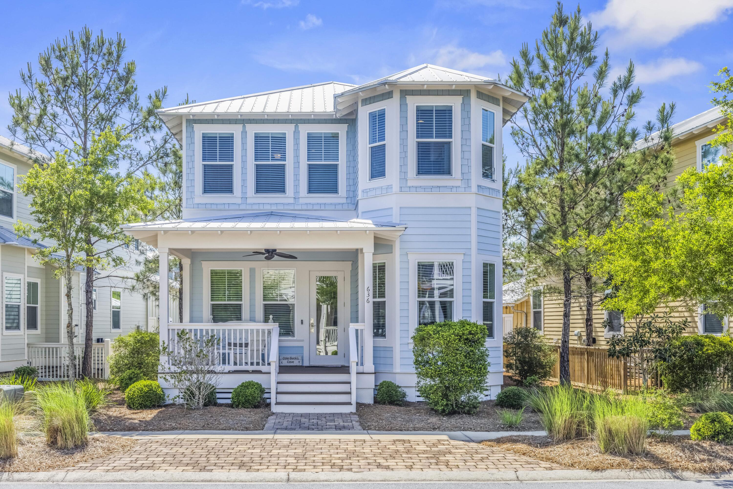 636 Flatwoods Forest Loop Santa Rosa Beach, FL 32459 - Photo 1 of 36 a front view of a house with garden