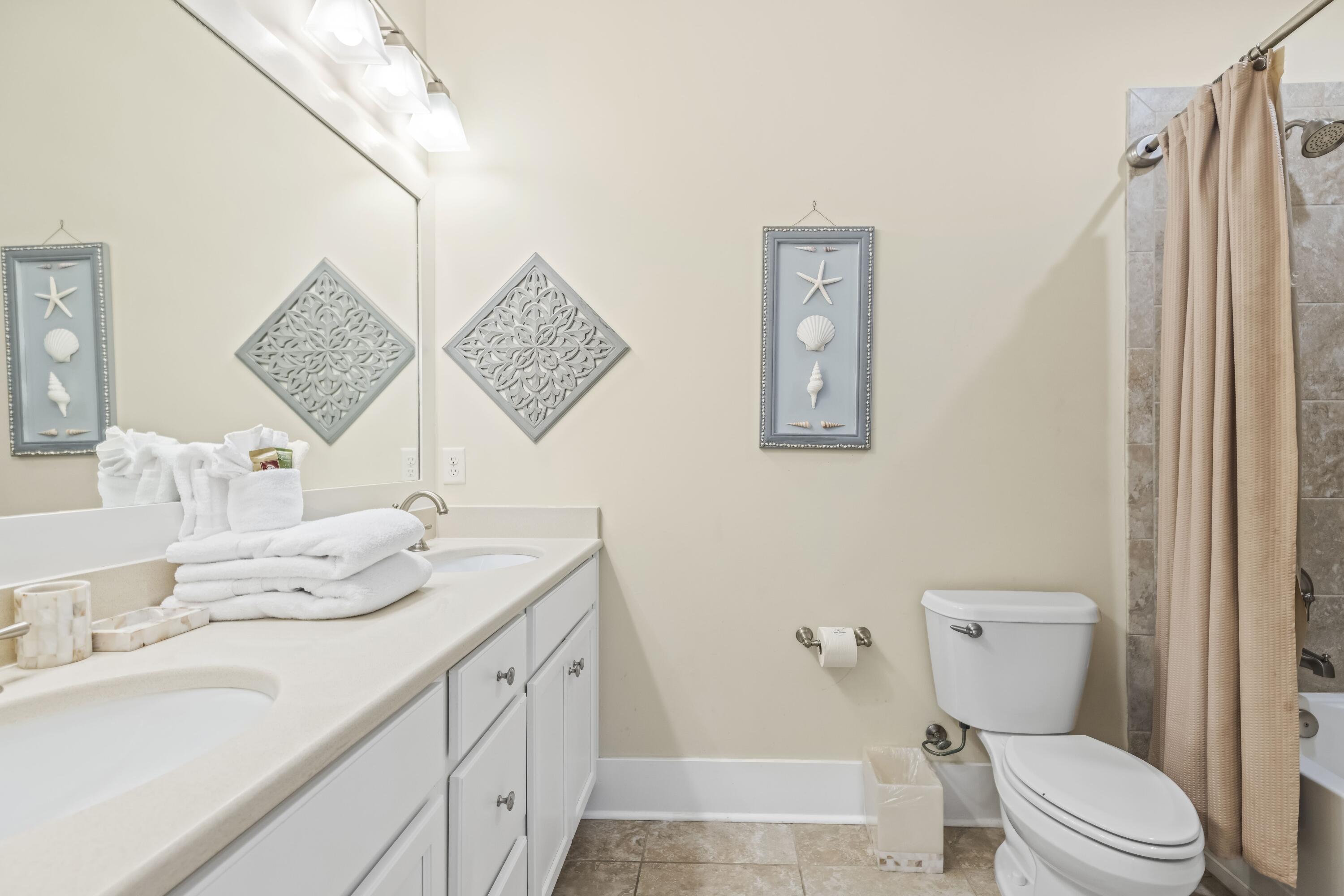 636 Flatwoods Forest Loop Santa Rosa Beach, FL 32459 - Photo 17 of 36 a bathroom with a toilet sink and mirror