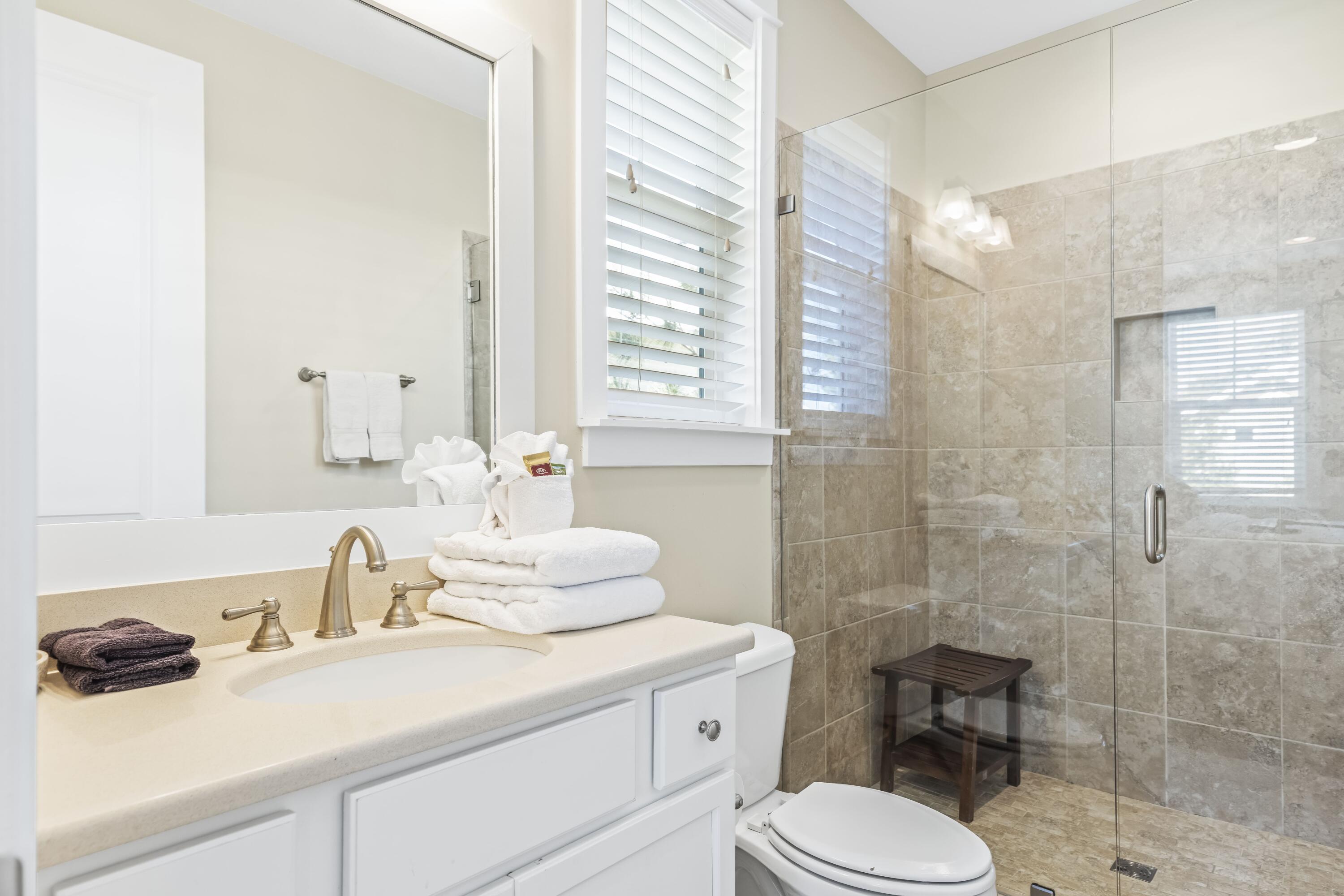 636 Flatwoods Forest Loop Santa Rosa Beach, FL 32459 - Photo 19 of 36 a bathroom with a sink a toilet and shower
