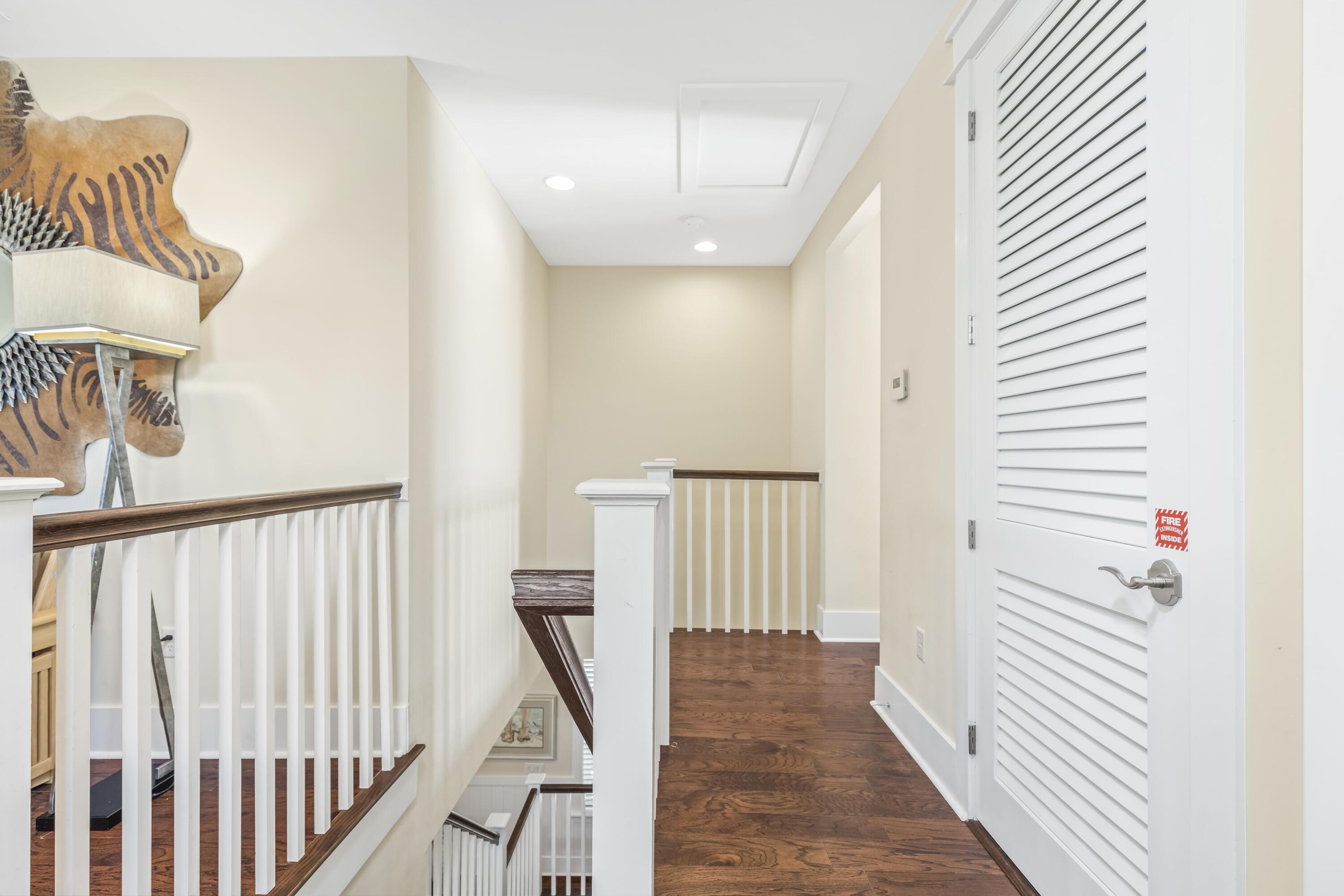 636 Flatwoods Forest Loop Santa Rosa Beach, FL 32459 - Photo 21 of 36 a view of a hallway with wooden floor and staircase