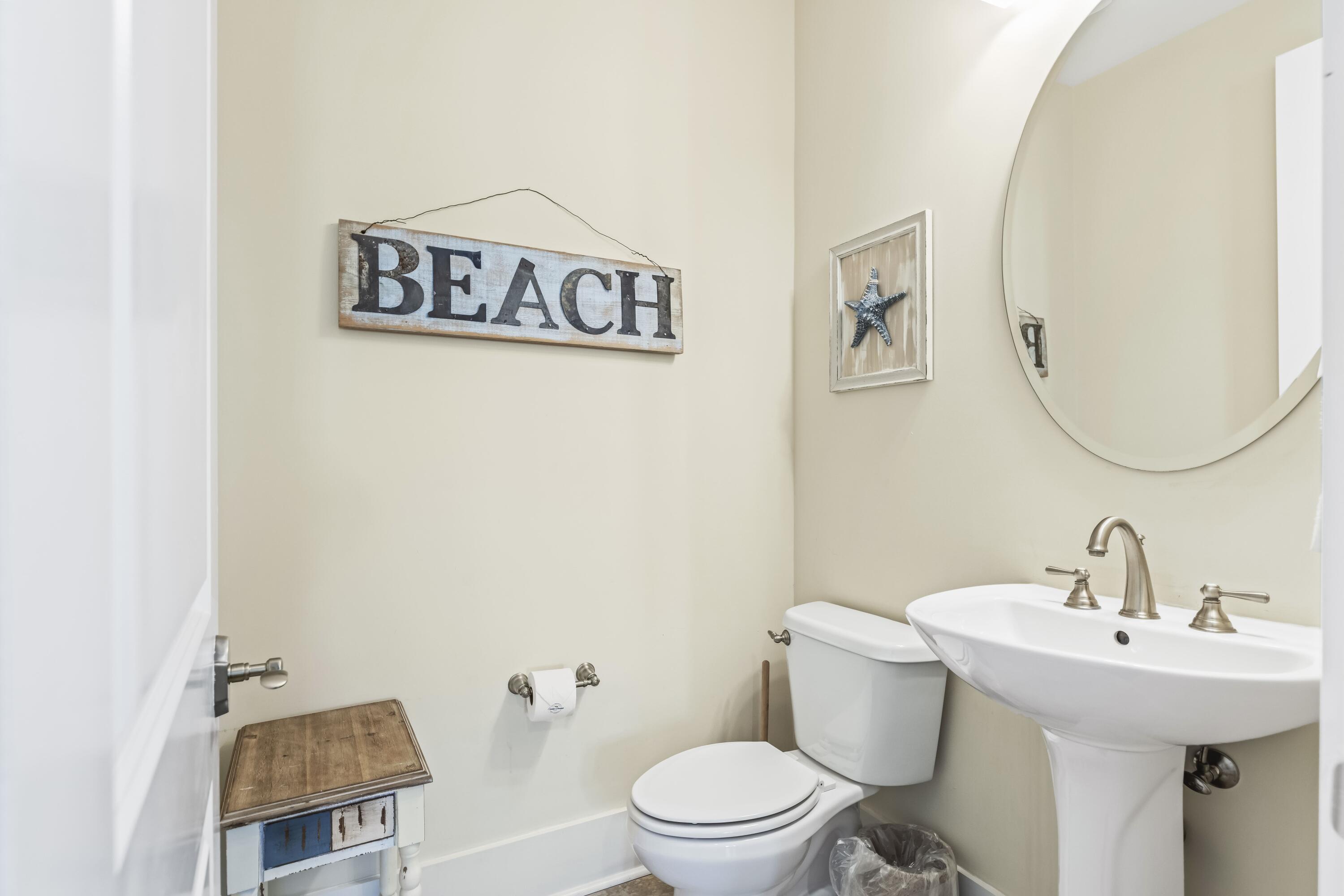 636 Flatwoods Forest Loop Santa Rosa Beach, FL 32459 - Photo 23 of 36 a bathroom with a toilet a sink and mirror