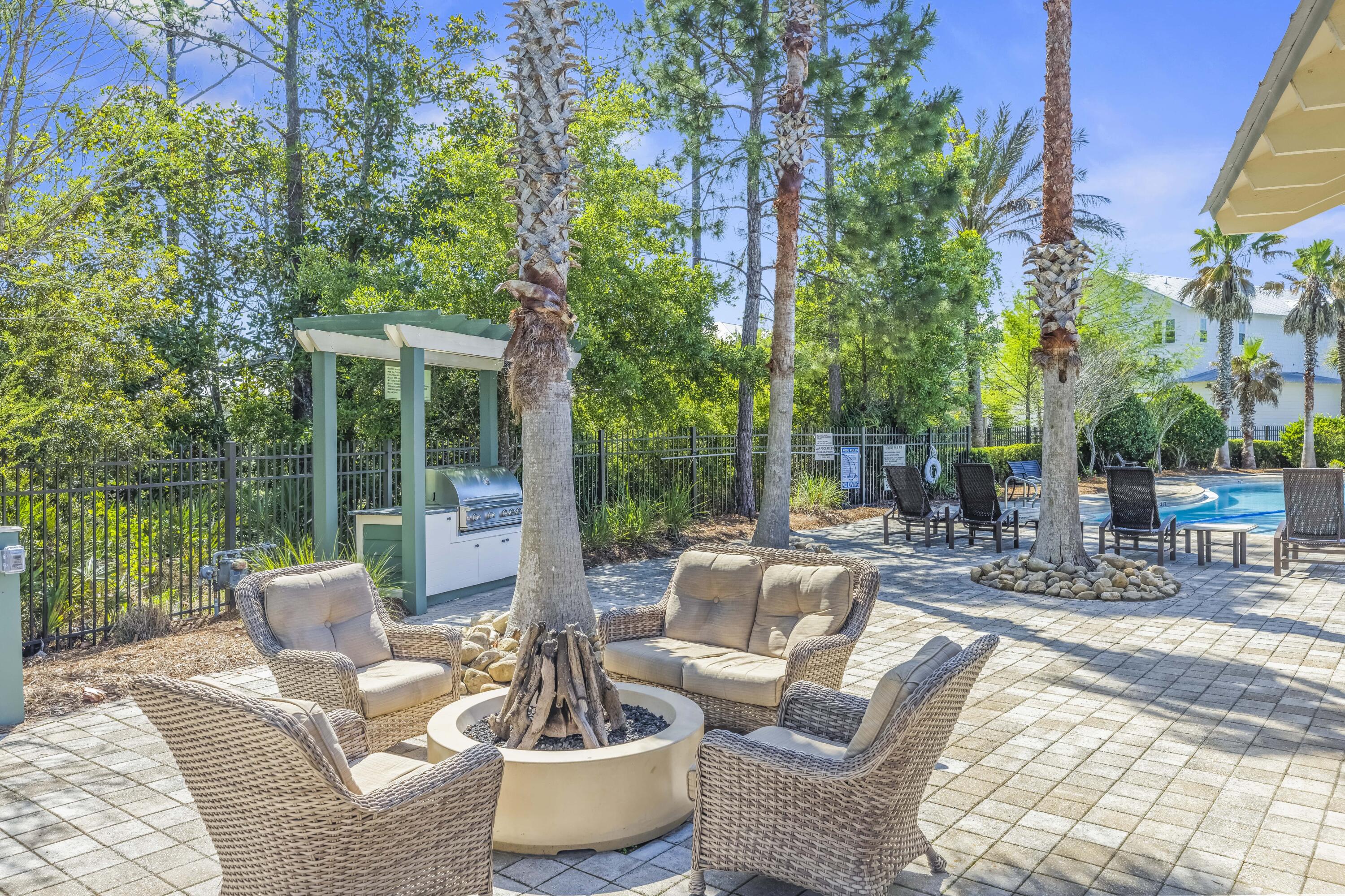 636 Flatwoods Forest Loop Santa Rosa Beach, FL 32459 - Photo 31 of 36 a view of a patio with couches chairs and a potted plant