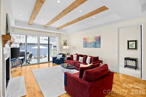 a living room with furniture a large window and a flat screen tv