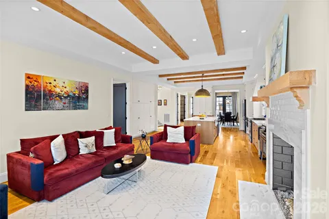 a living room with fireplace furniture and a large window