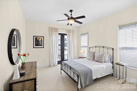 a bedroom with a large bed and a chandelier