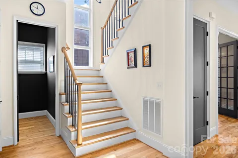 a view of a hallway with wooden floor and entryway
