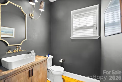 a bathroom with a sink a toilet and a mirror