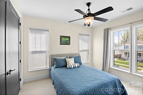 a bedroom with a bed and window