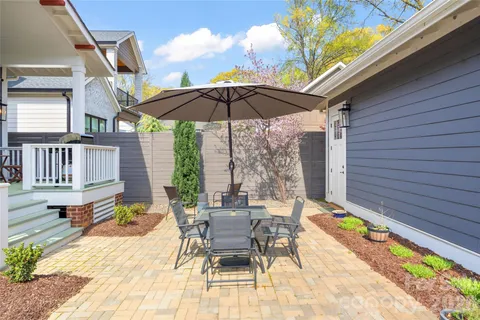 a view of a patio with a table chairs and a backyard