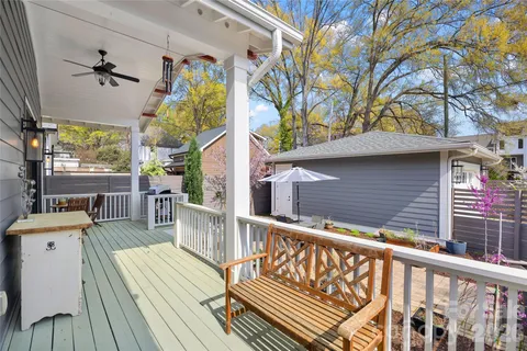 a view of balcony with wooden floor and outdoor seating