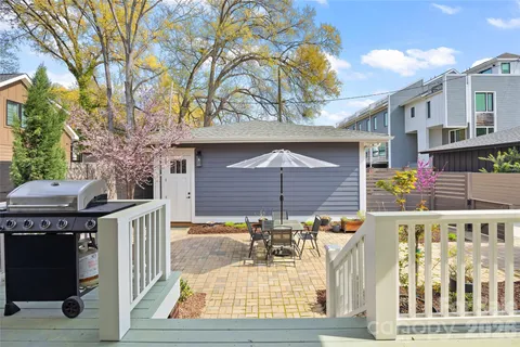a view of a patio with table and chairs and wooden floor
