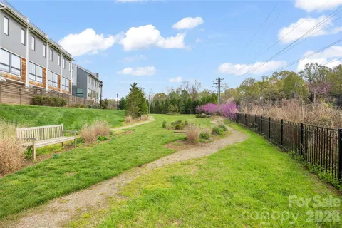 a view of a garden with a building in the background