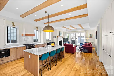 a kitchen with sink and view living room