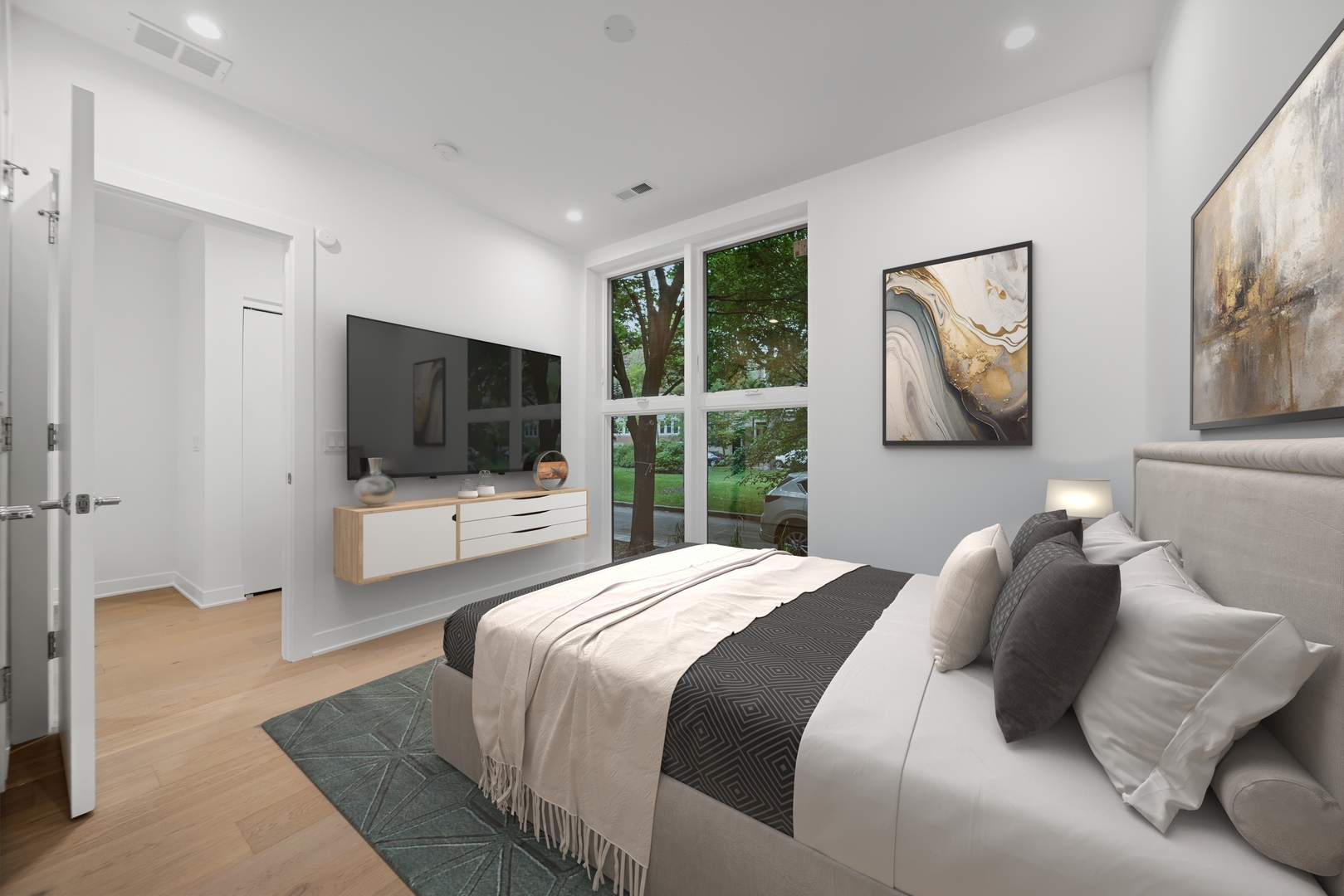 1333 East Madison Park Chicago, IL 60615 - Photo 19 of 32 a bedroom with a bed and a flat screen tv