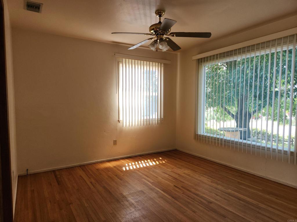 3525 Calavo Drive Spring Valley, CA 91978 - Photo 12 of 21 a view of an empty room with wooden floor and a window