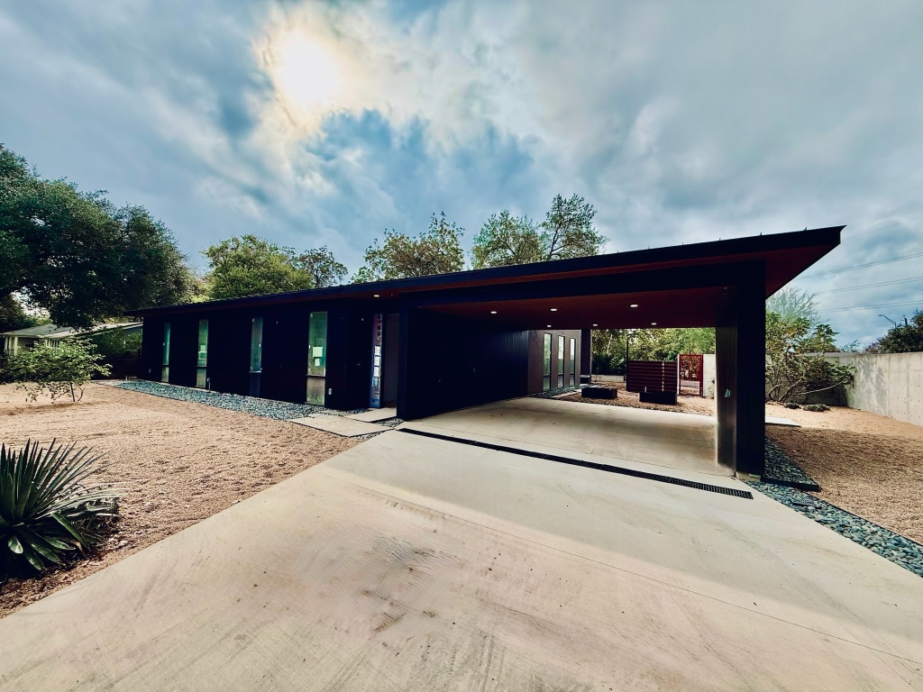 3007 Perry Lane Austin, TX 78731 - Photo 13 of 24 a view of a house with a yard and garage