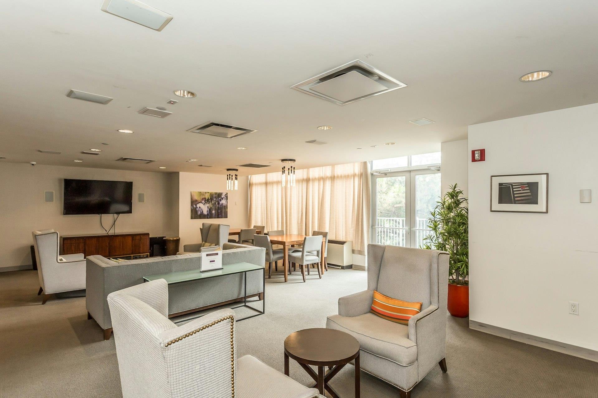 131-03 40 Road, Unit 10E Queens, NY 11354 - Photo 12 of 15 a living room with furniture and a large window