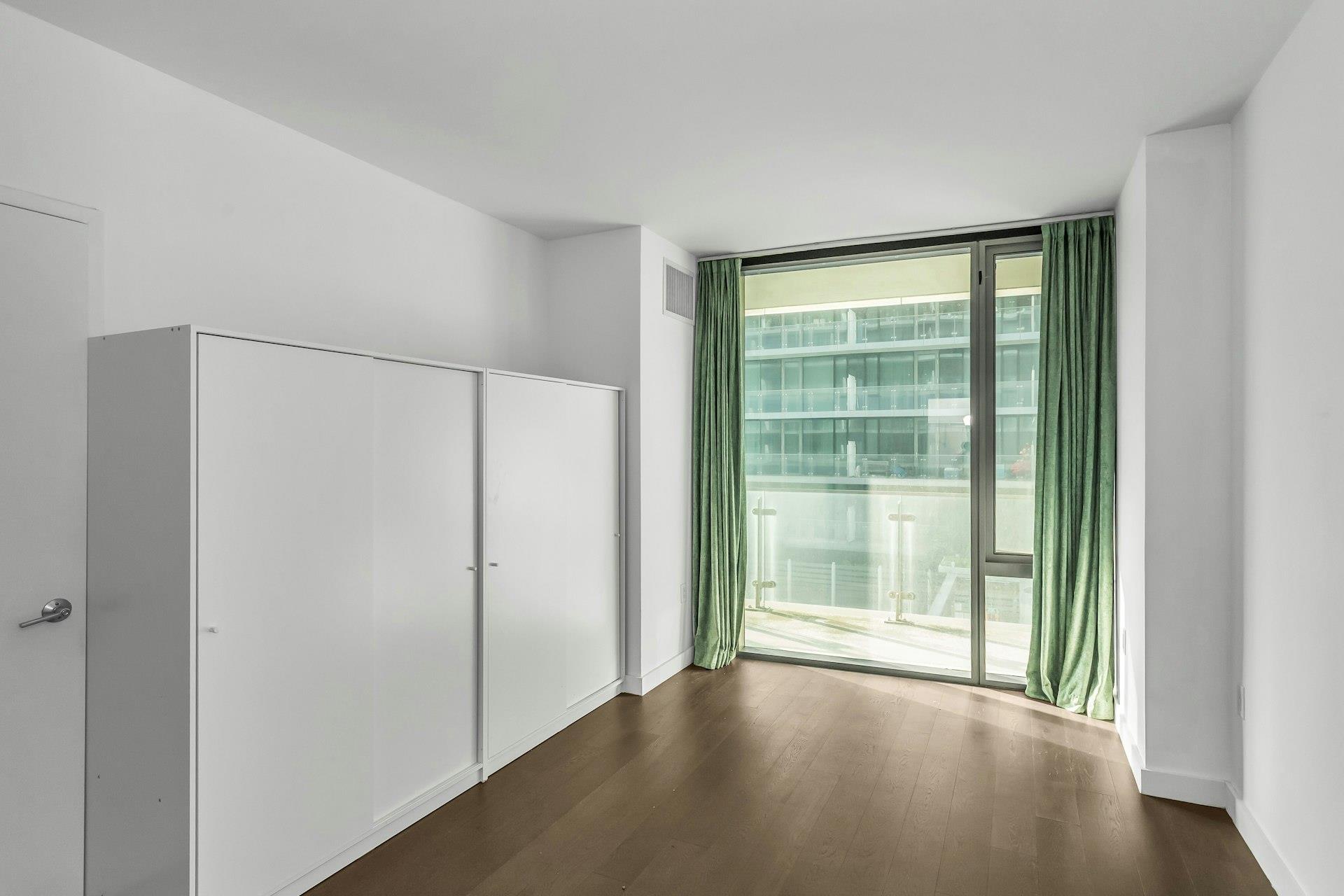 131-03 40 Road, Unit 10E Queens, NY 11354 - Photo 9 of 15 a view of a room with a large window