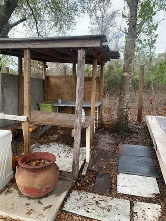 a view of a yard with wooden fence
