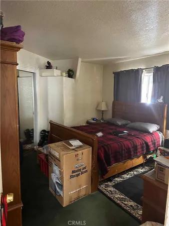 a bedroom with bed and window