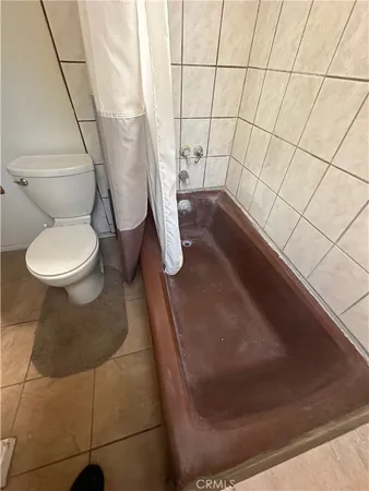 a bathroom with a toilet and a mirror