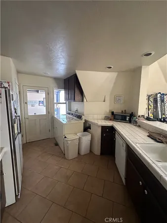 a kitchen with a sink refrigerator and microwave