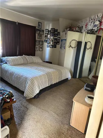 a bedroom with bed and wooden floor