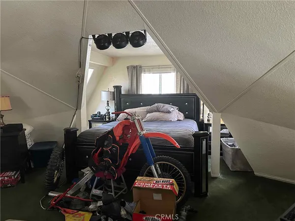a bed room with a bed and a ceiling fan
