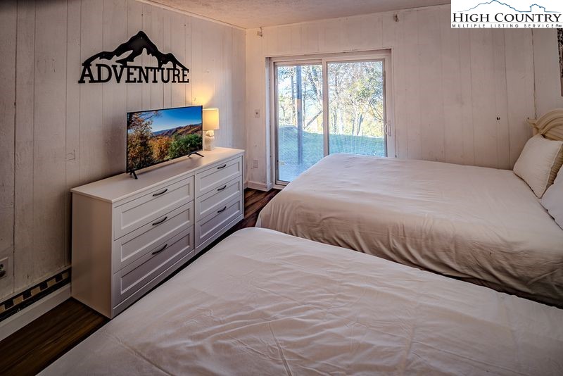 115 North Pinnacle Ridge Road, Unit 47 Beech Mountain, NC 28604 - Photo 15 of 33 a bedroom with a bed and a flat tv screen on dresser