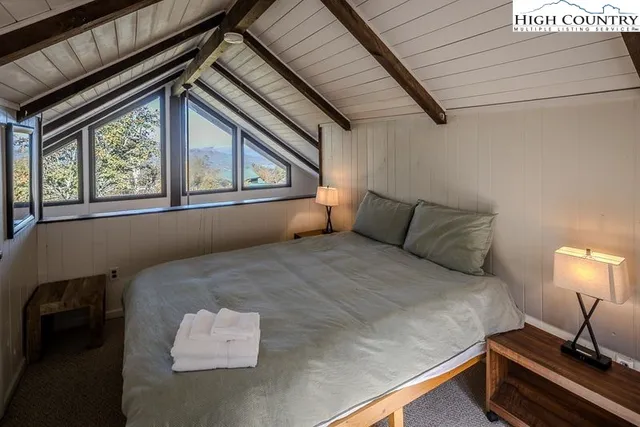 a bed sitting in a bedroom next to a window