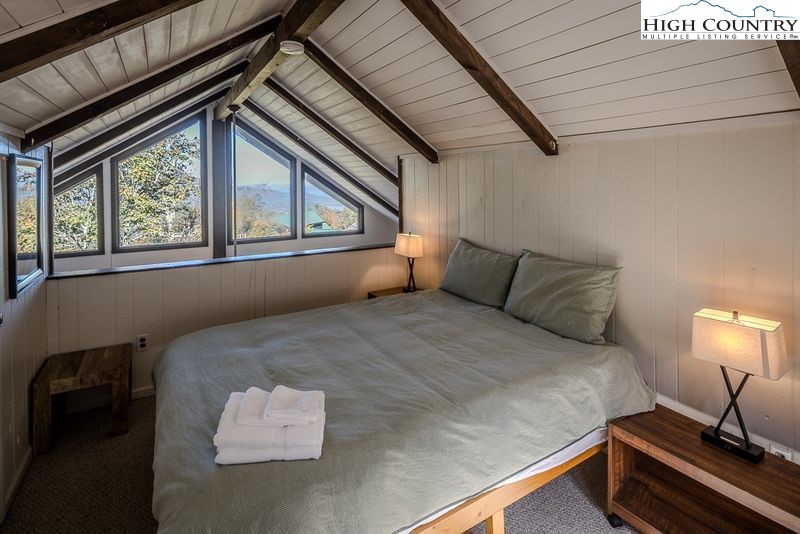 115 North Pinnacle Ridge Road, Unit 47 Beech Mountain, NC 28604 - Photo 19 of 33 a bed sitting in a bedroom next to a window