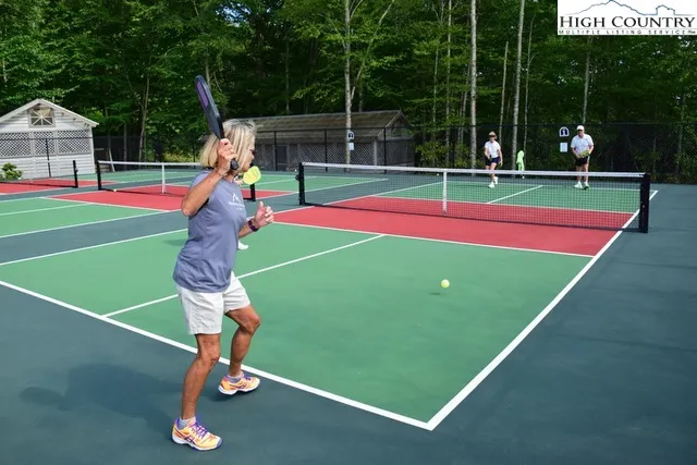 a view of backyard with swimming pool and outdoor seating