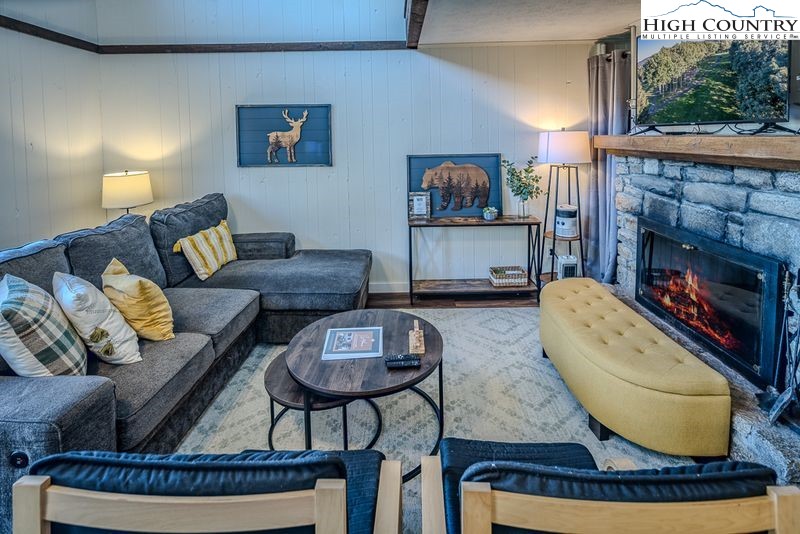 115 North Pinnacle Ridge Road, Unit 47 Beech Mountain, NC 28604 - Photo 3 of 33 a living room with furniture and a fireplace