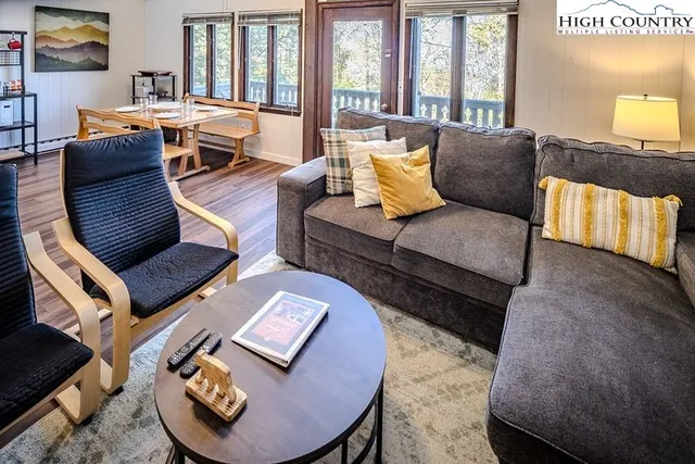 a living room with furniture and wooden floor
