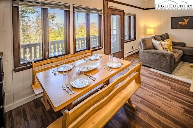 a living room with furniture and large windows