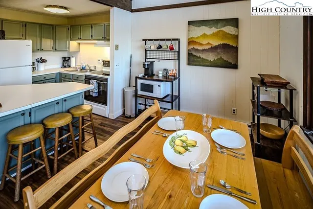 a dining room with furniture and wooden floor
