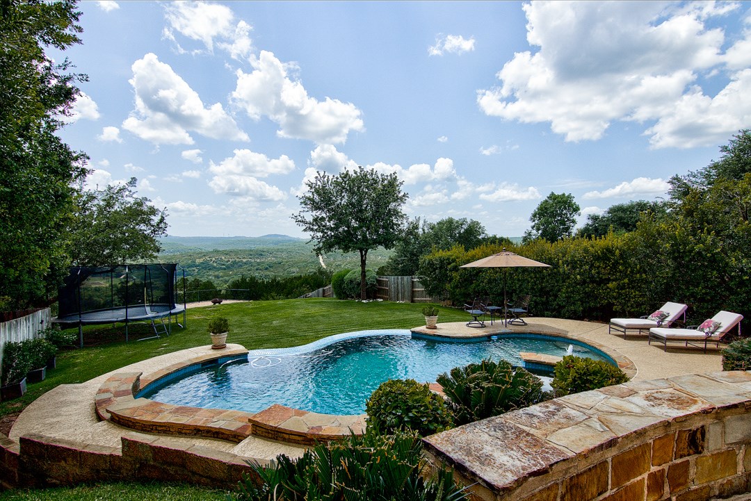 a view of a swimming pool patio and outdoor seating